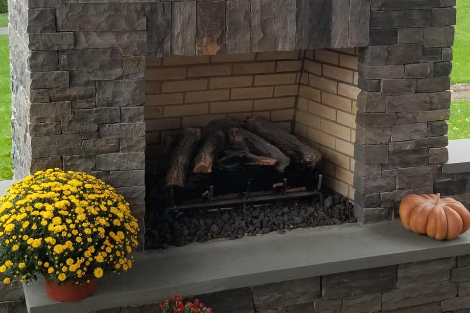 A stone fireplace and chimney.